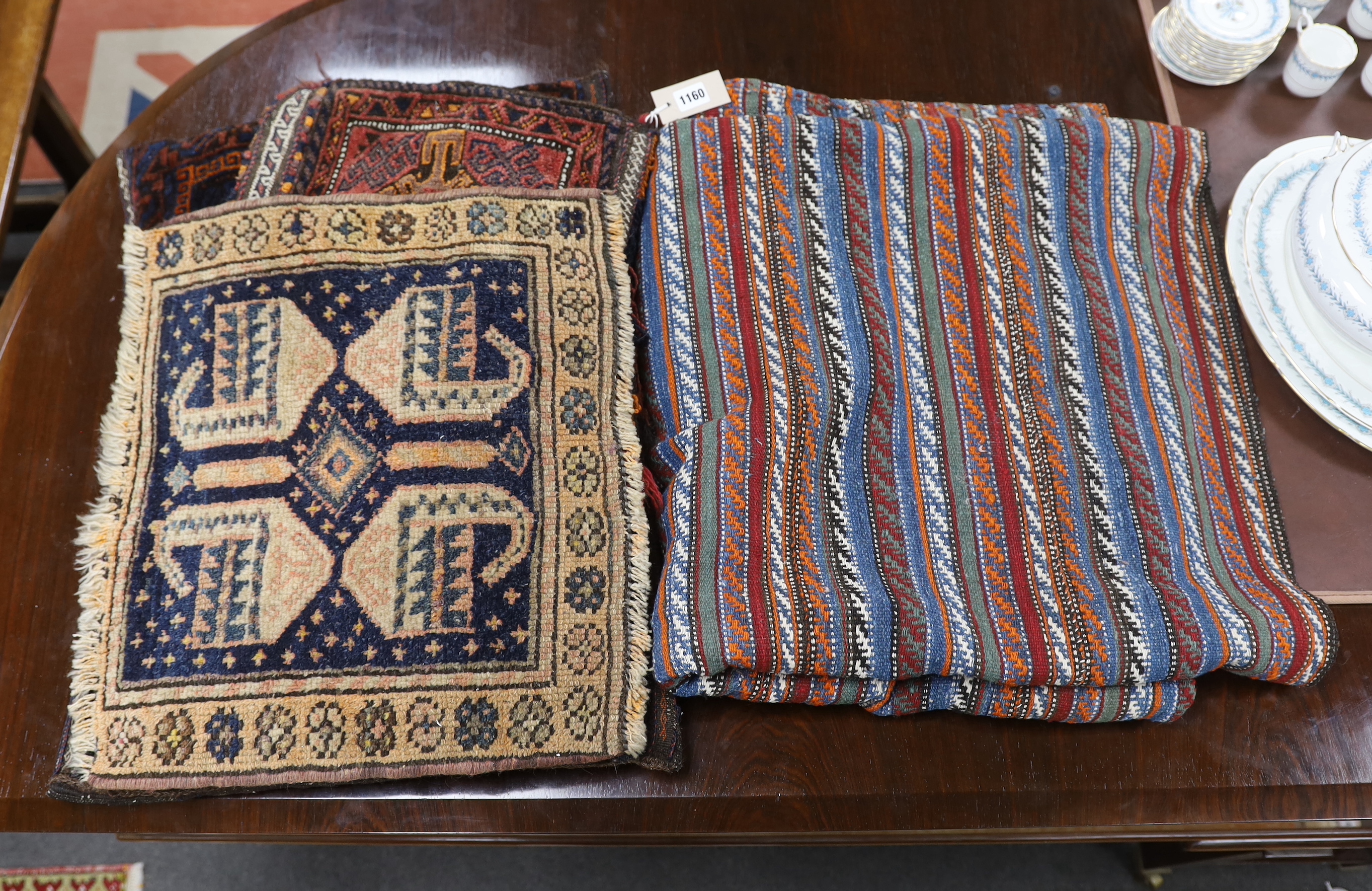 A Belouch cushion, two textile fragments, a Caucasian geometric salt bag, Caucasian mat and a flatweave rug, largest 220 x 205cm